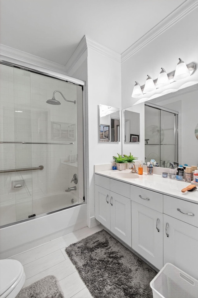 12562 Crystal Pointe Dr Unit B, Boynton Beach, FL 33437 - bathroom featuring crown molding, vanity, enclosed tub / shower combo, and toilet
