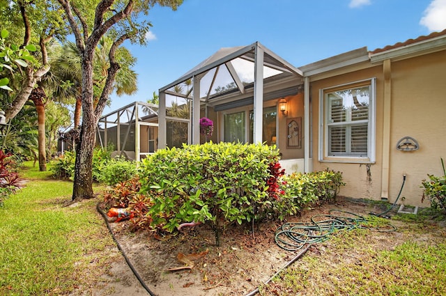 12562 Crystal Pointe Dr Unit B, Boynton Beach, FL 33437 - view of property exterior featuring stucco siding and a lanai