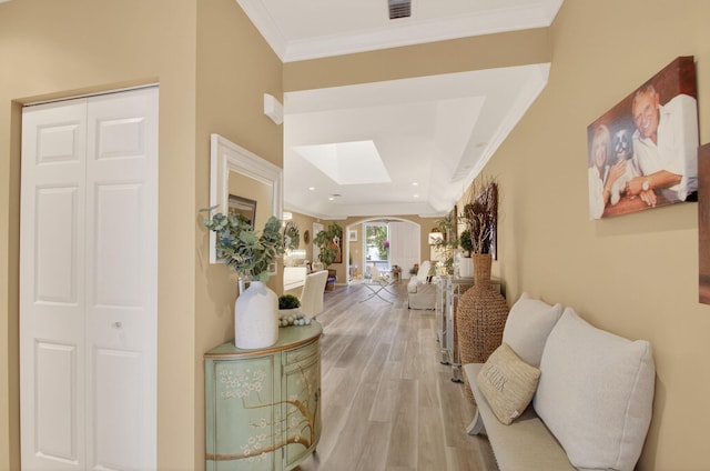 12562 Crystal Pointe Dr Unit B, Boynton Beach, FL 33437 - hallway featuring crown molding, light wood-style floors, a skylight, and arched walkways