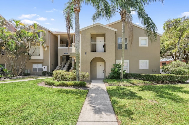 1825 Palm Cove Blvd Unit 109, Delray Beach, FL 33445 - view of front of home featuring stucco siding, a front yard, and stairway
