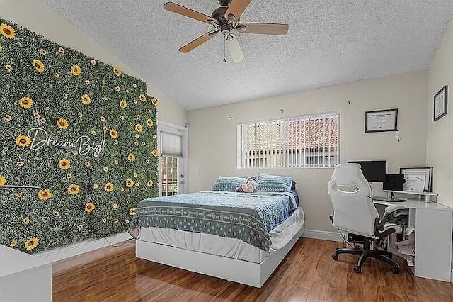 12 Via De Casas Sur Unit 203, Boynton Beach, FL 33426 - bedroom featuring a textured ceiling, wood finished floors, a desk, and ceiling fan
