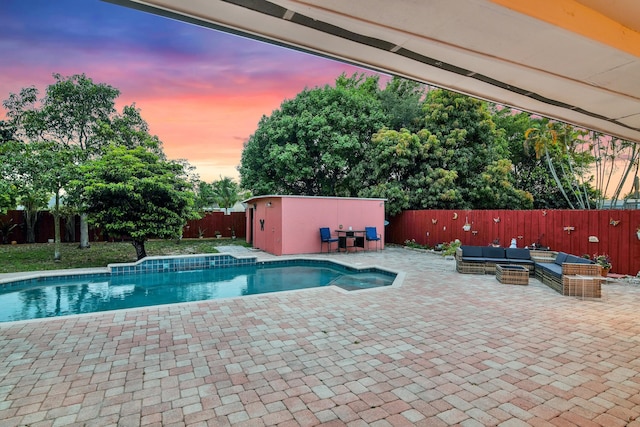 121 W Arch Dr (), Unit Lake Worth, FL 33467 - pool at dusk featuring outdoor lounge area, a fenced backyard, and a patio