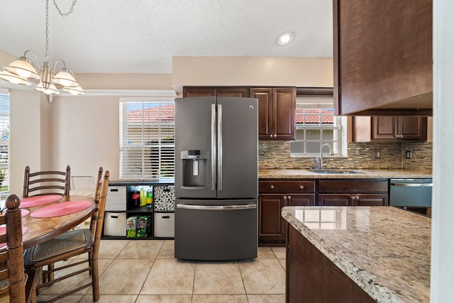 13277 Opal Ln, Wellington, FL 33414 - kitchen featuring stainless steel fridge, dishwasher, tasteful backsplash, dark brown cabinetry, and a textured ceiling