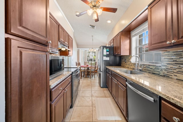 13277 Opal Ln, Wellington, FL 33414 - kitchen with stainless steel appliances, backsplash, a textured ceiling, plenty of natural light, and light stone counters