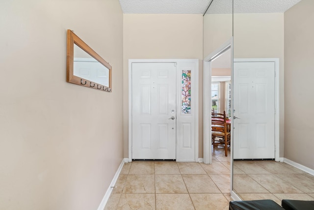13277 Opal Ln, Wellington, FL 33414 - entryway featuring light tile patterned floors and a textured ceiling