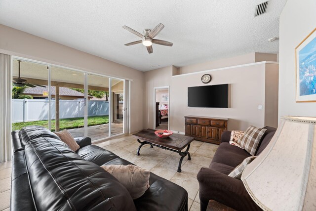 13277 Opal Ln, Wellington, FL 33414 - living room featuring a ceiling fan, a textured ceiling, and light tile patterned floors