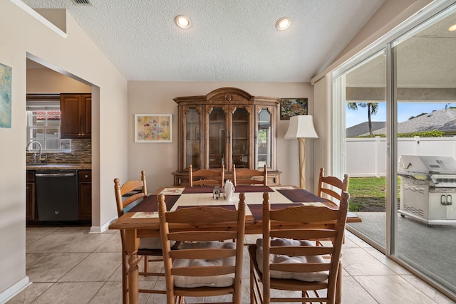 13277 Opal Ln, Wellington, FL 33414 - dining area with a textured ceiling, light tile patterned flooring, and vaulted ceiling