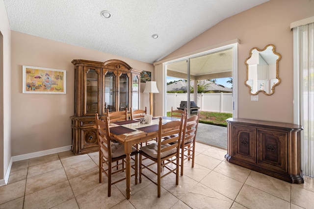 13277 Opal Ln, Wellington, FL 33414 - dining area featuring vaulted ceiling, light tile patterned floors, and a textured ceiling