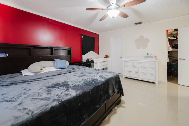 5402 Bonky Ct Unit 102B, West Palm Beach, FL 33415 - bedroom with a textured ceiling, ceiling fan, and a spacious closet
