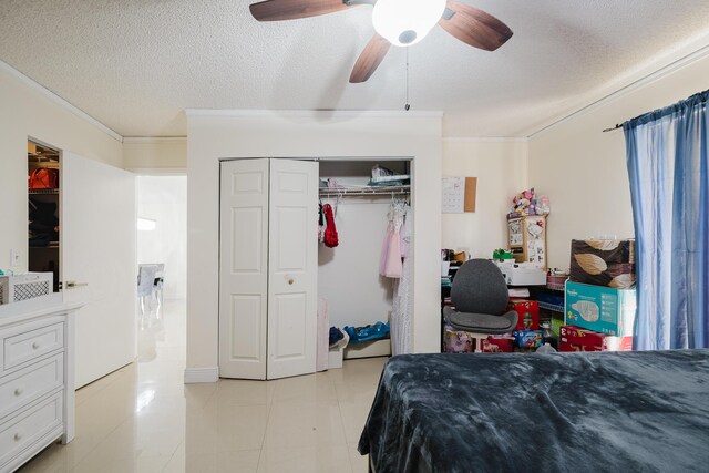 5402 Bonky Ct Unit 102B, West Palm Beach, FL 33415 - bedroom featuring ornamental molding, a textured ceiling, a closet, ceiling fan, and light tile patterned flooring