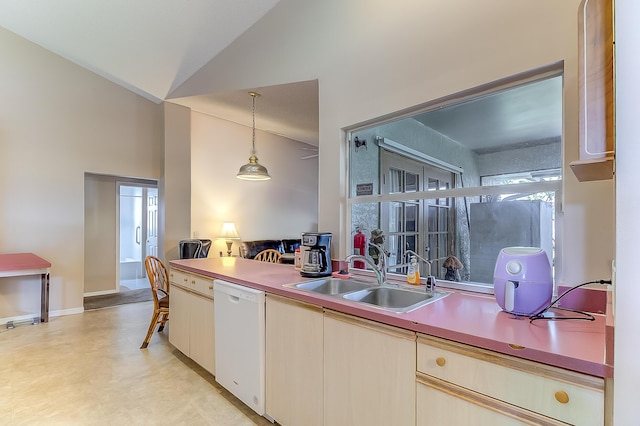 3892 SW Jablo St, Port Saint Lucie, FL 34953 - kitchen with white dishwasher, a sink, vaulted ceiling, decorative light fixtures, and baseboards