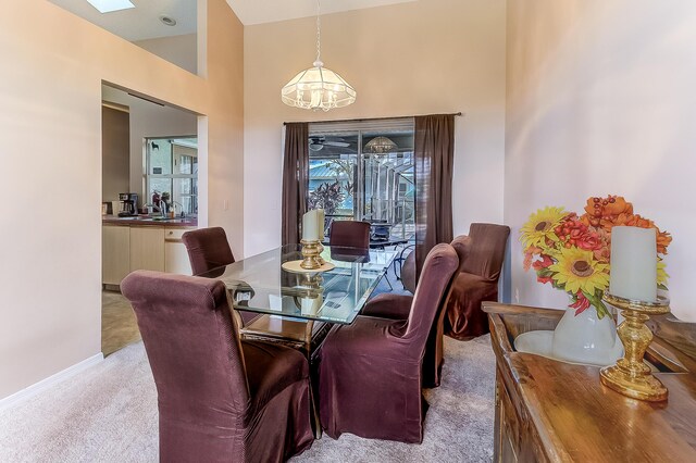 3892 SW Jablo St, Port Saint Lucie, FL 34953 - carpeted dining area with a chandelier and a high ceiling