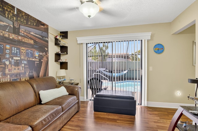 9844 Boca Gardens Cir N Unit D, Boca Raton, FL 33496 - living area with wood finished floors, a ceiling fan, a textured ceiling, and baseboards