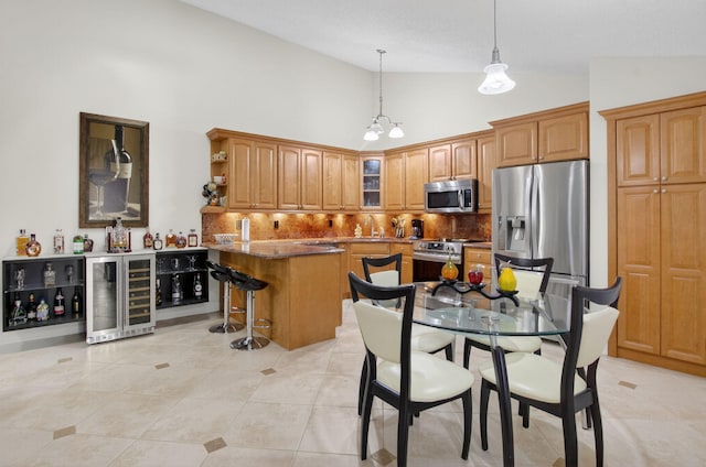 9844 Boca Gardens Cir N Unit D, Boca Raton, FL 33496 - kitchen featuring wine cooler, stainless steel appliances, lofted ceiling, tasteful backsplash, and glass insert cabinets