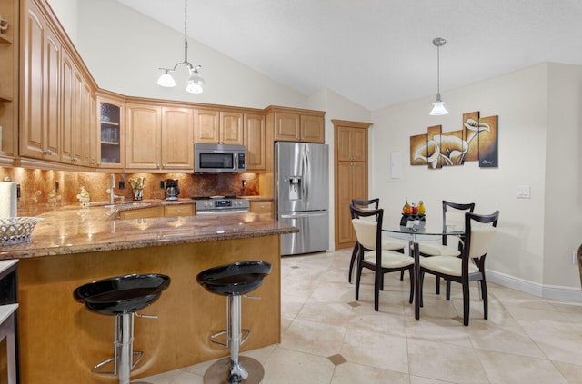9844 Boca Gardens Cir N Unit D, Boca Raton, FL 33496 - kitchen featuring stainless steel appliances, stone counters, backsplash, lofted ceiling, and glass insert cabinets