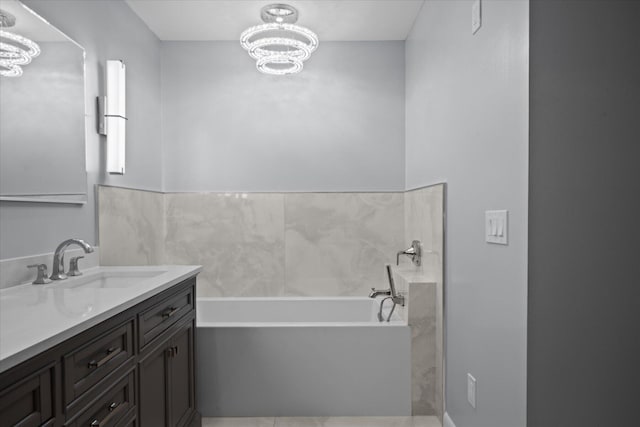 11038 Monet Ln, Palm Beach Gardens, FL 33410 - bathroom featuring a chandelier, vanity, and a bath