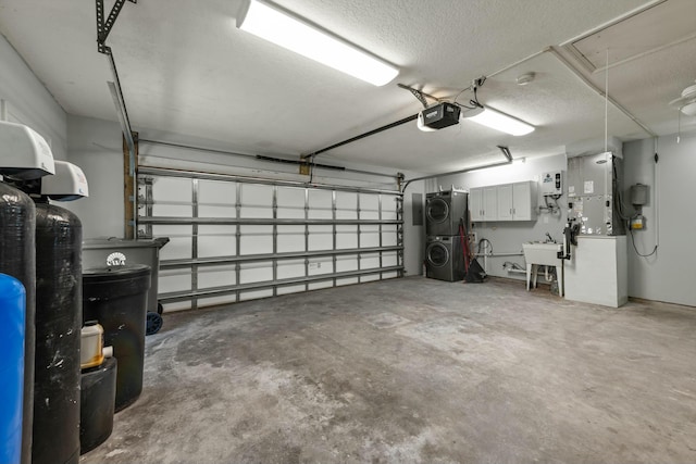 11038 Monet Ln, Palm Beach Gardens, FL 33410 - garage with stacked washer / drying machine and a garage door opener
