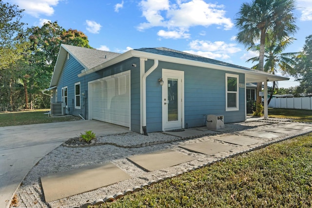 11038 Monet Ln, Palm Beach Gardens, FL 33410 - view of home's exterior with driveway, a garage, and a shingled roof
