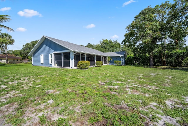 11038 Monet Ln, Palm Beach Gardens, FL 33410 - back of house featuring a sunroom and a yard