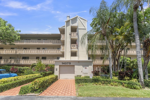 14375 Strathmore Ln Unit 306, Delray Beach, FL 33446 - view of apartment building / complex featuring a garage
