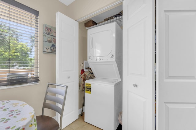 14375 Strathmore Ln Unit 306, Delray Beach, FL 33446 - washroom with estacked washer and dryer and light tile patterned flooring