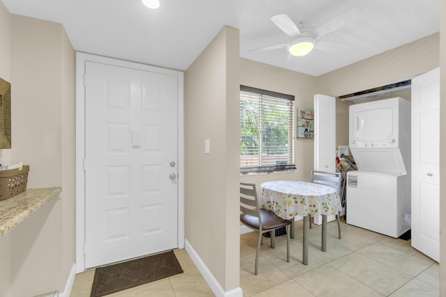 14375 Strathmore Ln Unit 306, Delray Beach, FL 33446 - entrance foyer featuring stacked washing machine and dryer, light tile patterned floors, and a ceiling fan