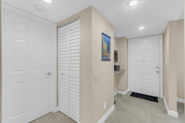 14375 Strathmore Ln Unit 306, Delray Beach, FL 33446 - foyer with light tile patterned floors, recessed lighting, and a textured ceiling