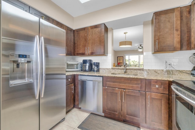 14375 Strathmore Ln Unit 306, Delray Beach, FL 33446 - kitchen with stainless steel appliances, backsplash, light stone counters, a ceiling fan, and light tile patterned floors