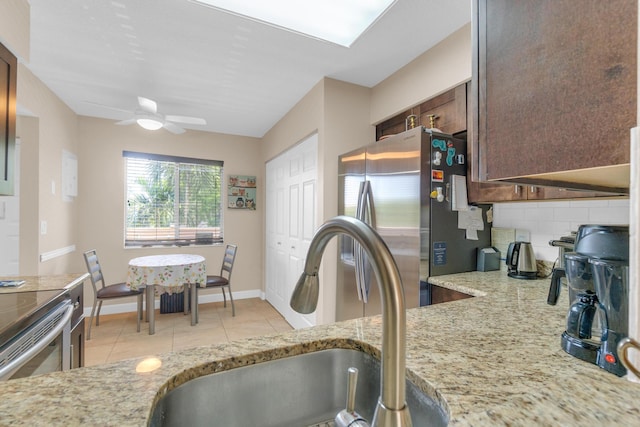 14375 Strathmore Ln Unit 306, Delray Beach, FL 33446 - kitchen featuring stainless steel appliances, ceiling fan, tasteful backsplash, light stone countertops, and dark brown cabinetry