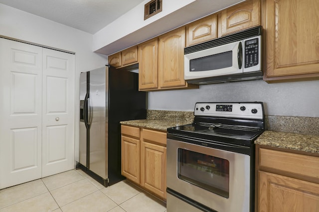 261 SW Palm Dr Unit 205, Port Saint Lucie, FL 34986 - kitchen with stainless steel appliances, light tile patterned flooring, and dark stone countertops