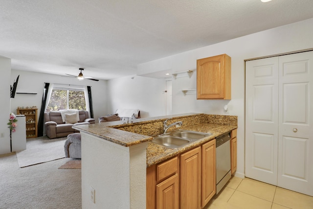 261 SW Palm Dr Unit 205, Port Saint Lucie, FL 34986 - kitchen featuring a peninsula, stainless steel dishwasher, a sink, a textured ceiling, and ceiling fan