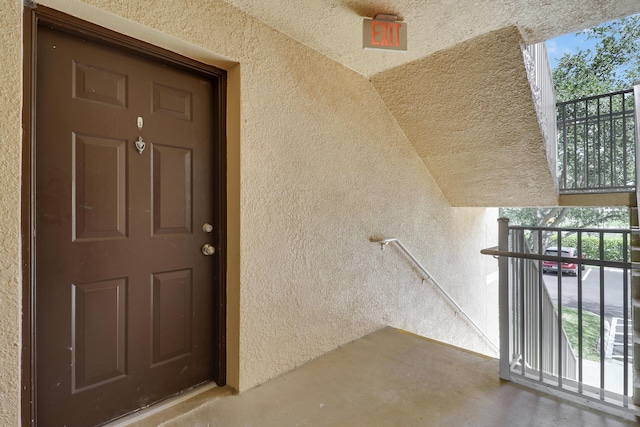 261 SW Palm Dr Unit 205, Port Saint Lucie, FL 34986 - view of exterior entry featuring stucco siding and a balcony
