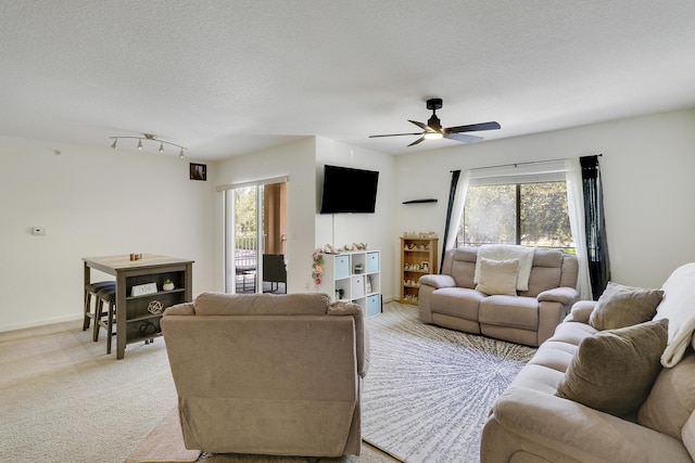 261 SW Palm Dr Unit 205, Port Saint Lucie, FL 34986 - living area with light colored carpet, healthy amount of natural light, ceiling fan, and a textured ceiling