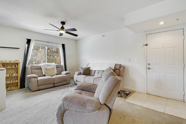 261 SW Palm Dr Unit 205, Port Saint Lucie, FL 34986 - tiled living room featuring carpet floors, a ceiling fan, and baseboards