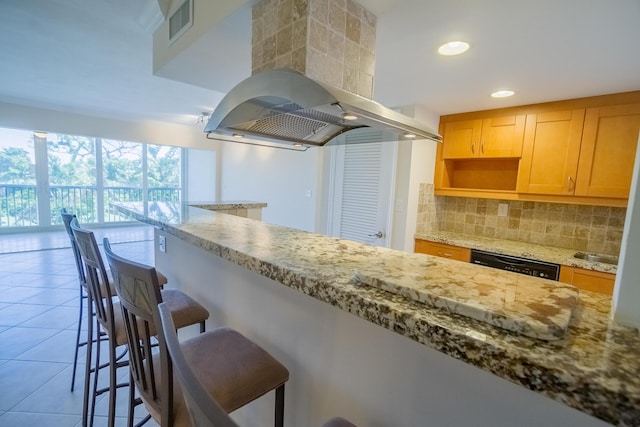 300 E Royal Palm Rd Unit 42B, Boca Raton, FL 33432 - kitchen with island exhaust hood, dishwashing machine, tasteful backsplash, a kitchen breakfast bar, and tile patterned flooring