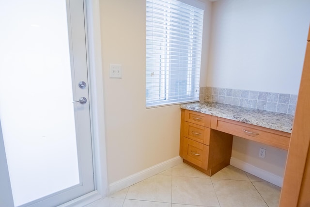 300 E Royal Palm Rd Unit 42B, Boca Raton, FL 33432 - unfurnished office with built in desk, light tile patterned flooring, and baseboards