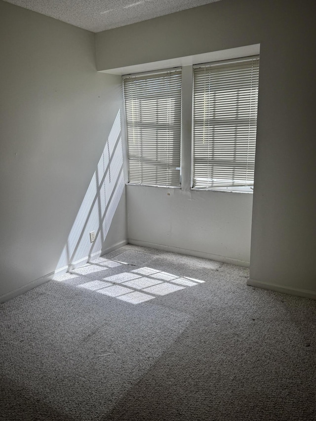 4348 Hazel Ave Unit B, Palm Beach Gardens, FL 33410 - unfurnished room with carpet floors, healthy amount of natural light, baseboards, and a textured ceiling