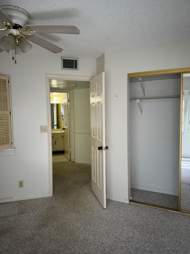 4348 Hazel Ave Unit B, Palm Beach Gardens, FL 33410 - unfurnished bedroom featuring carpet flooring, a closet, a textured ceiling, ceiling fan, and baseboards