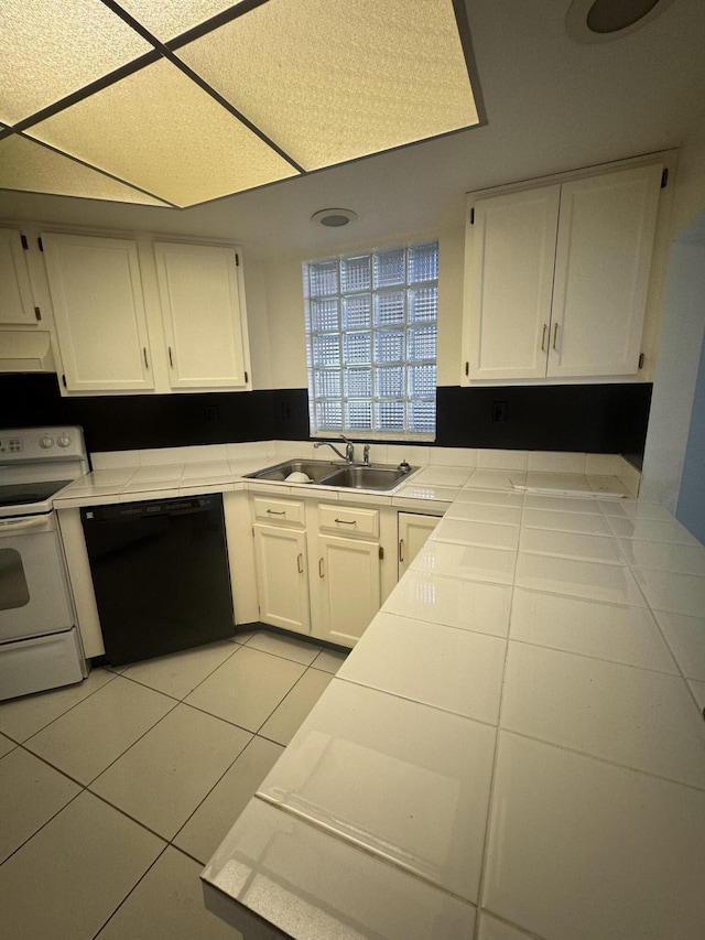 4348 Hazel Ave Unit B, Palm Beach Gardens, FL 33410 - kitchen with black dishwasher, white range with electric stovetop, tile countertops, and white cabinets