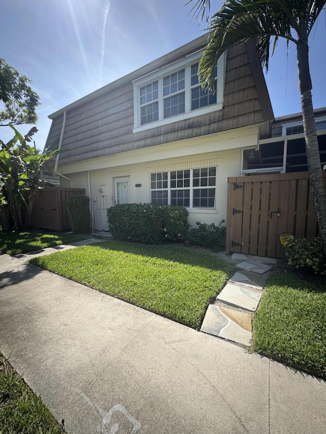 4348 Hazel Ave Unit B, Palm Beach Gardens, FL 33410 - view of front of house featuring a gate, mansard roof, and stucco siding