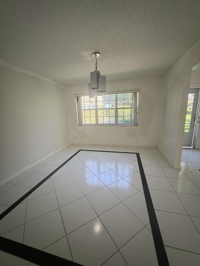 4348 Hazel Ave Unit B, Palm Beach Gardens, FL 33410 - spare room featuring tile patterned flooring, inlaid floor details, baseboards, a chandelier, and a textured ceiling