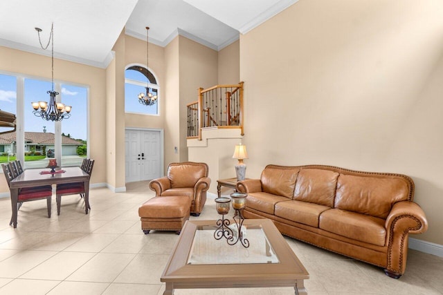 9556 E Lake Dr, Boca Raton, FL 33434 - living room featuring a chandelier, ornamental molding, plenty of natural light, light tile patterned floors, and a towering ceiling