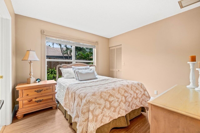 9556 E Lake Dr, Boca Raton, FL 33434 - bedroom featuring light wood-style flooring and a closet