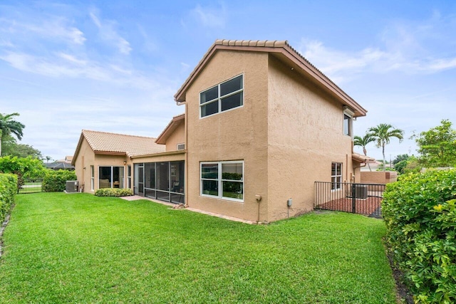 9556 E Lake Dr, Boca Raton, FL 33434 - rear view of property featuring stucco siding, a fenced backyard, a sunroom, and a tile roof