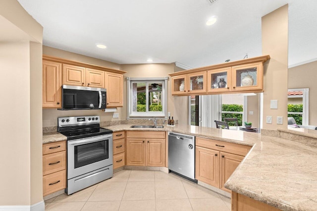 9556 E Lake Dr, Boca Raton, FL 33434 - kitchen with appliances with stainless steel finishes, light brown cabinets, light tile patterned floors, glass insert cabinets, and recessed lighting