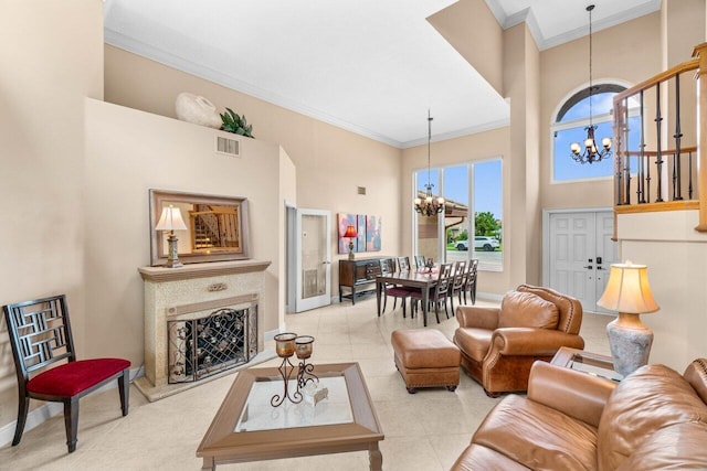 9556 E Lake Dr, Boca Raton, FL 33434 - living area featuring a chandelier, a high ceiling, ornamental molding, and a fireplace with raised hearth
