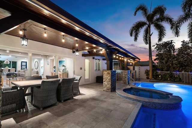 400 SE 5th Ter, Pompano Beach, FL 33060 - patio terrace at dusk featuring a patio, outdoor dining area, and a pool with connected hot tub