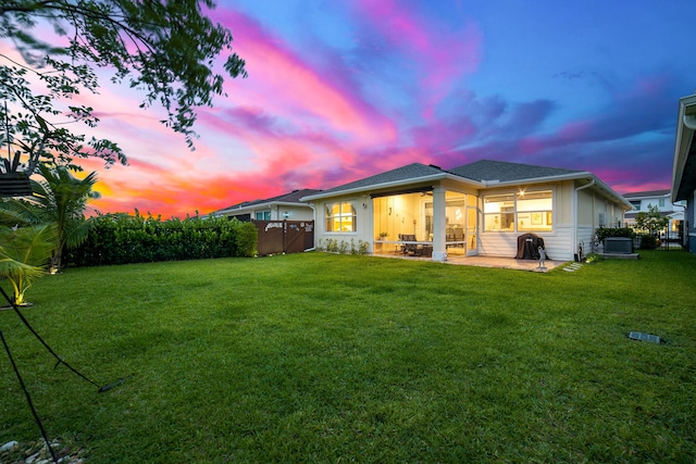 1233 Wandering Willow Way, Loxahatchee, FL 33470 - back of property at dusk featuring a ceiling fan, a patio, and central AC