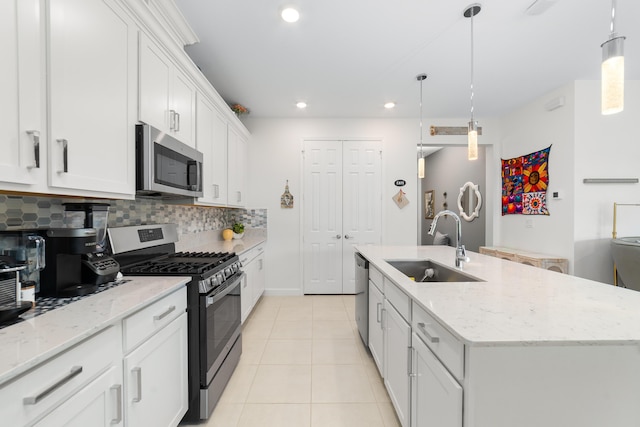 1233 Wandering Willow Way, Loxahatchee, FL 33470 - kitchen with appliances with stainless steel finishes, a sink, tasteful backsplash, light tile patterned floors, and a center island with sink