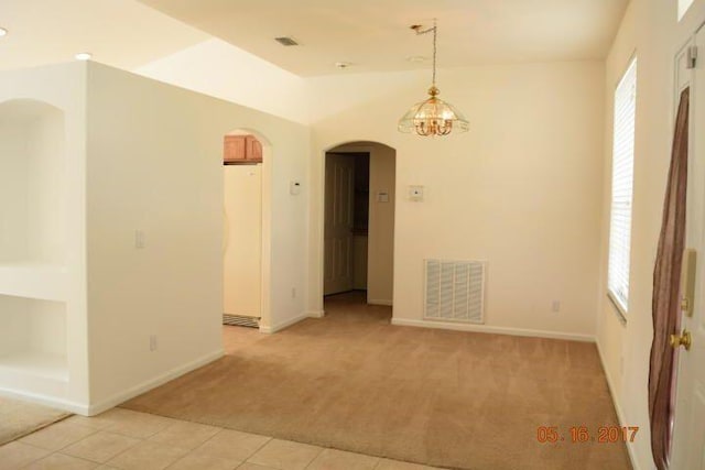 1701 SW Victor Ln SW, Port Saint Lucie, FL 34984 - unfurnished room with arched walkways, light carpet, light tile patterned floors, a chandelier, and baseboards